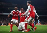 LONDON, ENGLAND - DECEMBER 10: Mesut Ozil of Arsenal celebrates scoring his sides second goal with his Arsenal team mates during the Premier League match between Arsenal and Stoke City at the Emirates Stadium on December 10, 2016 in London, England.  (Photo by Julian Finney/Getty Images)